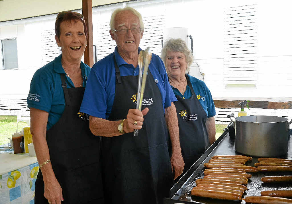 Cancer Council volunteers Jan Bryne, Ken Hartnett and Kay Wilson work the grill.
